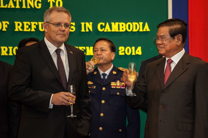 Scott Morrison celebrates with Cambodia's interior minister