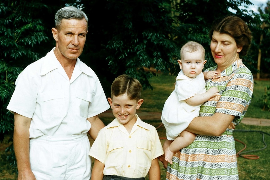 family of four, father, mother and two children circa 1950s