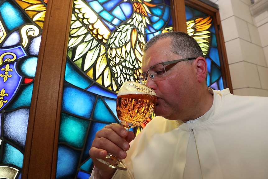 Norbertine Father Karel tastes a Grimbergen beer in the courtyard of the Belgian Abbey of Grimbergen.