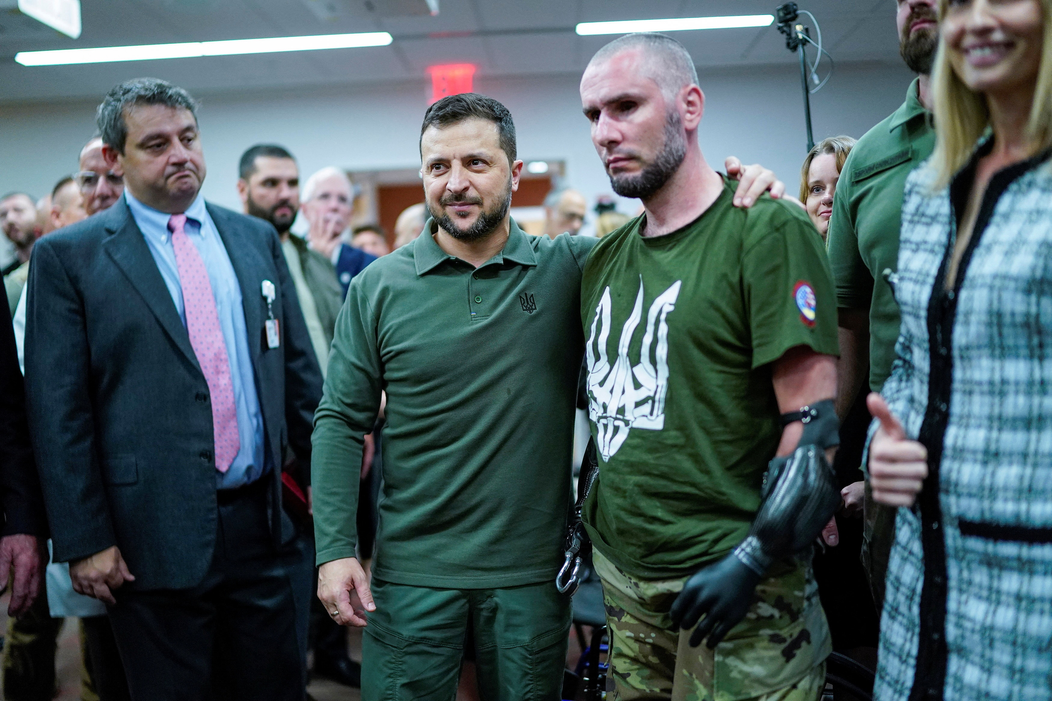 Zelenskyy stands with a soldier for a photo.