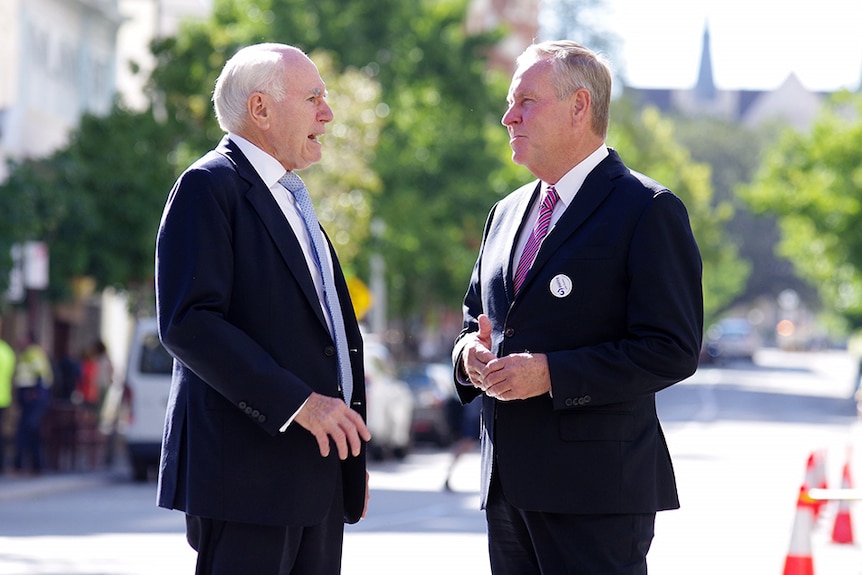 John Howard and Colin Barnett stand on a street talking.