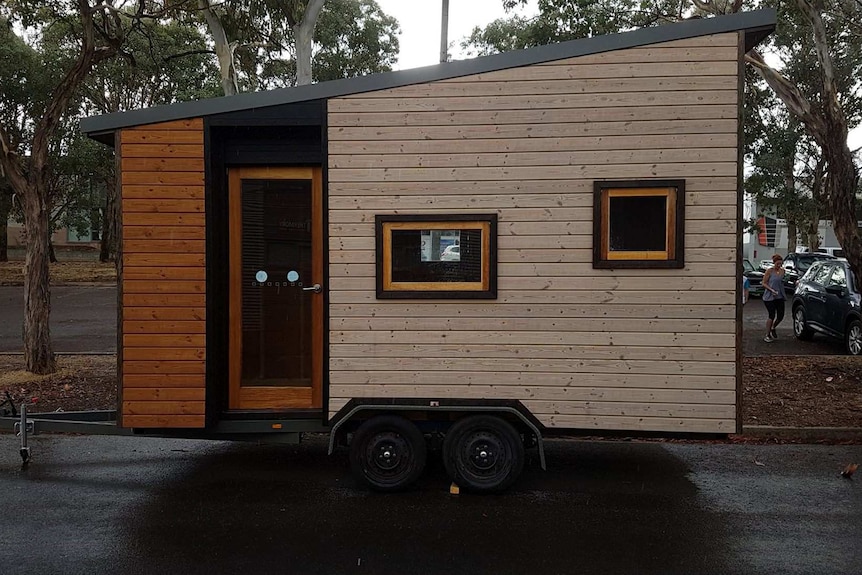 A small house-like structure mounted on a trailer.