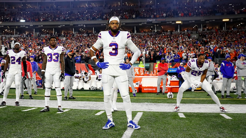 Buffalo Bills player Damar Hamlin stands on the sidelines before an NFL game.