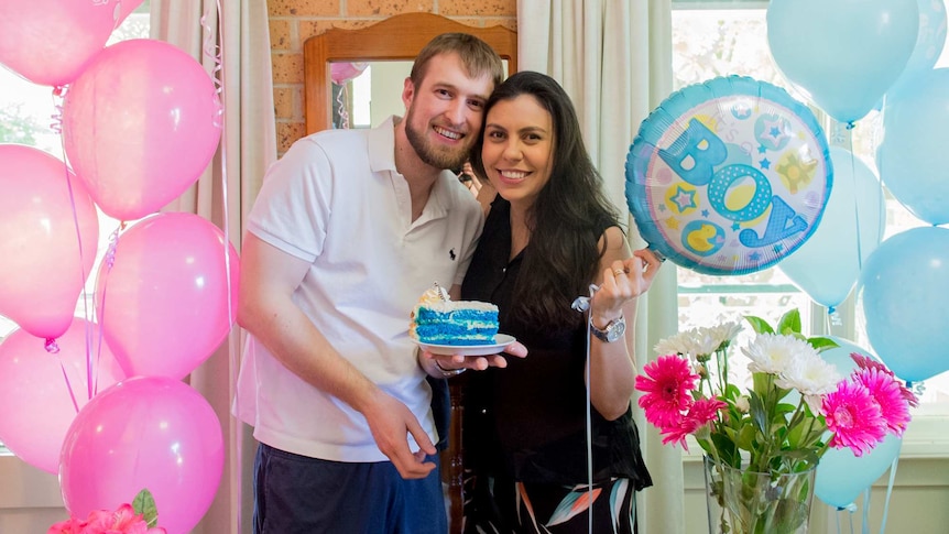 Canberra couple holding blue cake