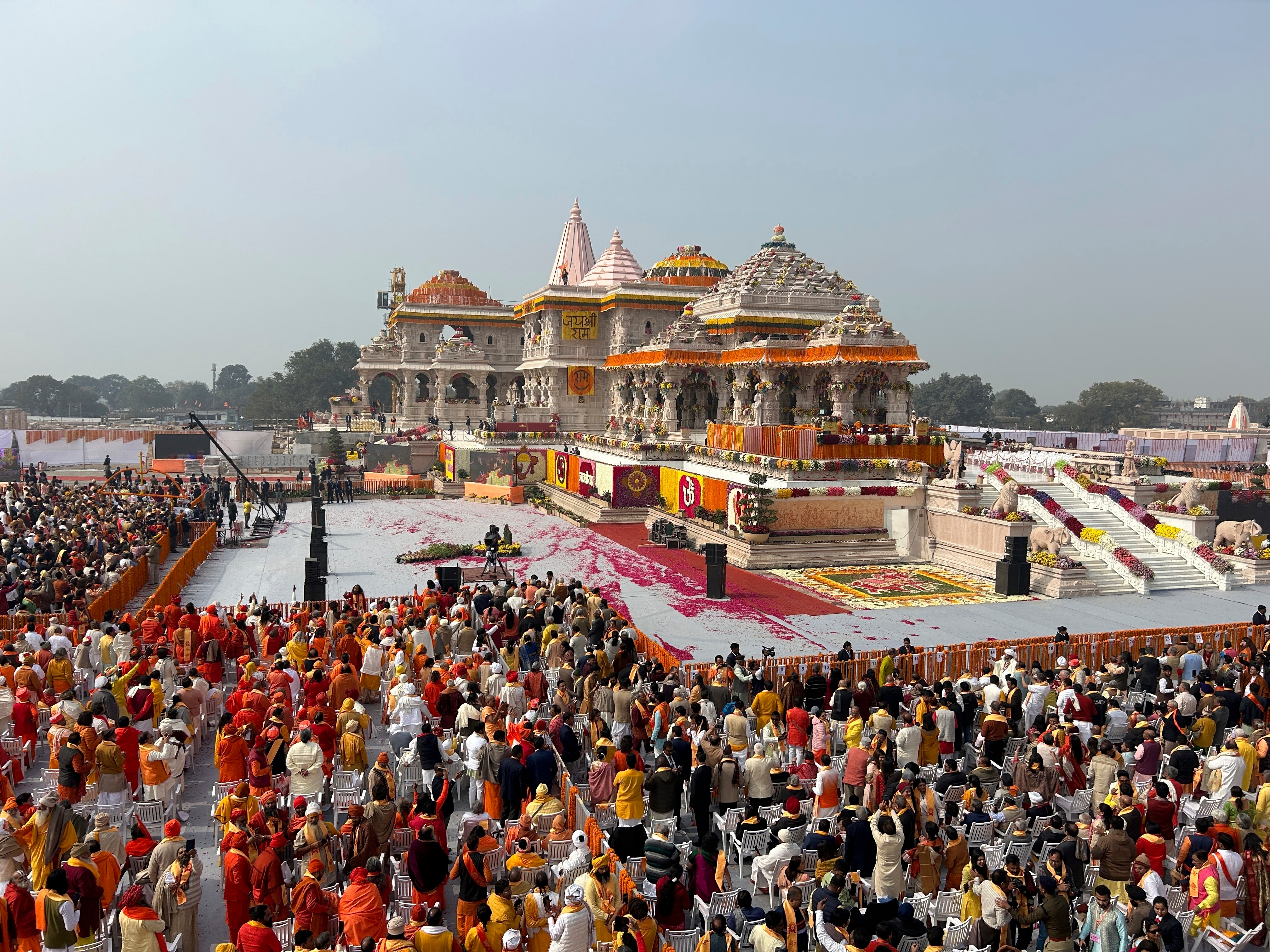 A crowd of people gathered outside a temple