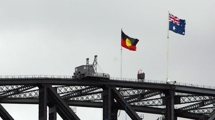 The Aboriginal and Australian flags fly over the Sydney Harbour Bridge