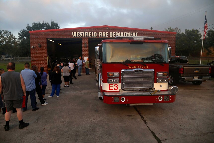 Residents wait in line to vote during the US midterms at a fire station in Houston, Texas.