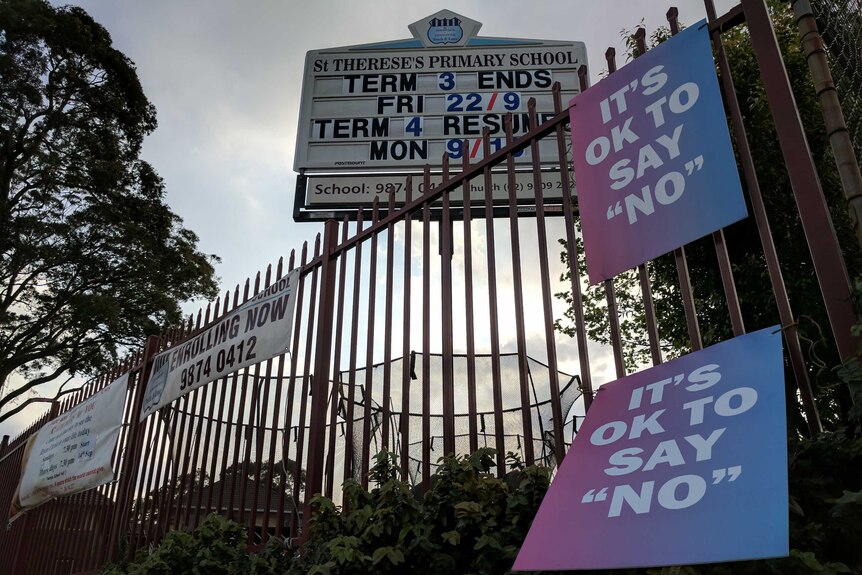 'It's Ok to Vote No' sign outside a primary school hanging on the fence