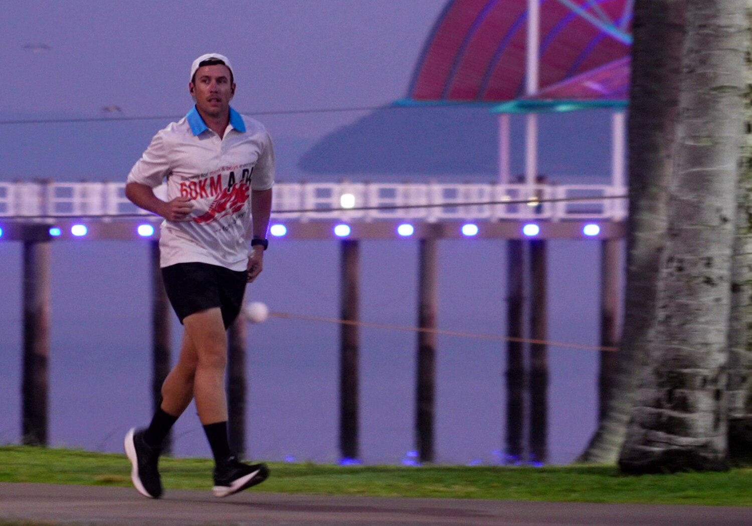 A man running along the Townsville waterfront at dawn