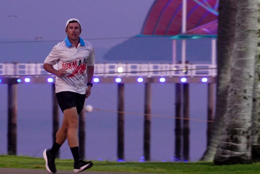 A man running along the Townsville waterfront at dawn