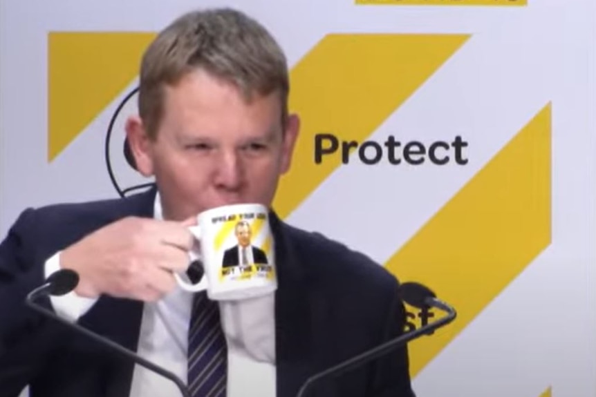 Image of New Zealand's incoming prime minister holding a mug to his mouth. 