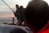 Turkish coastguard hitting refugees with sticks
