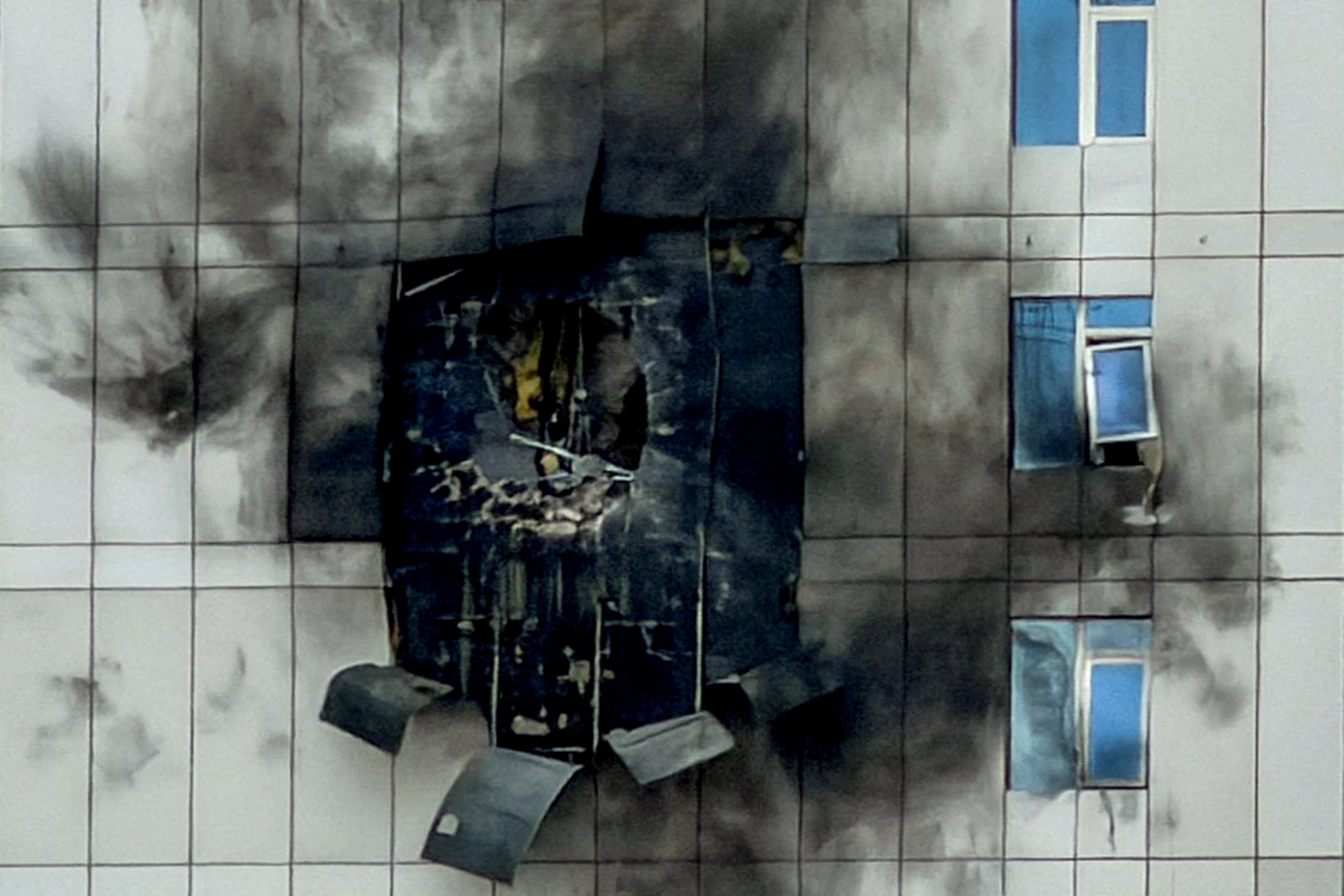 the side of a building damaged and burned