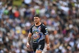 A man looks at the ground during the Indigenous All Stars rugby league match
