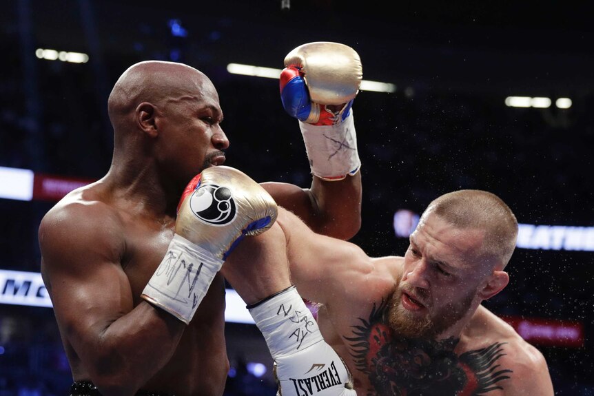 Conor McGregor swings his right elbow into Floyd Mayweather's jaw