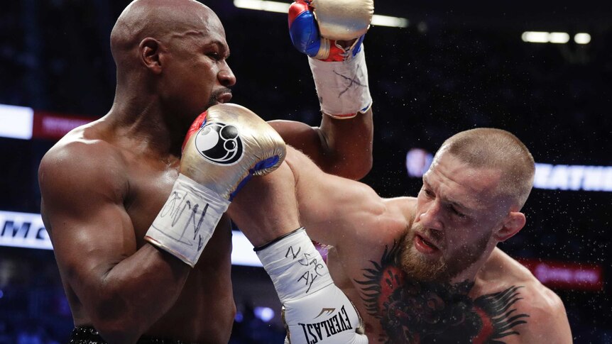 Conor McGregor swings his right elbow into Floyd Mayweather's jaw