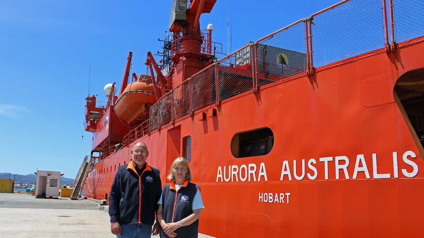 Dr Andrew Constable and Dr Gwen Fenton from the Australian Antarctic Division stand in front of the icebreaker Aurora Australis