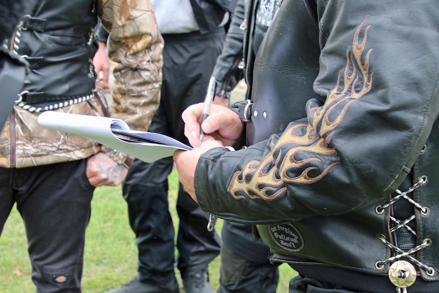 Biker signs a petition