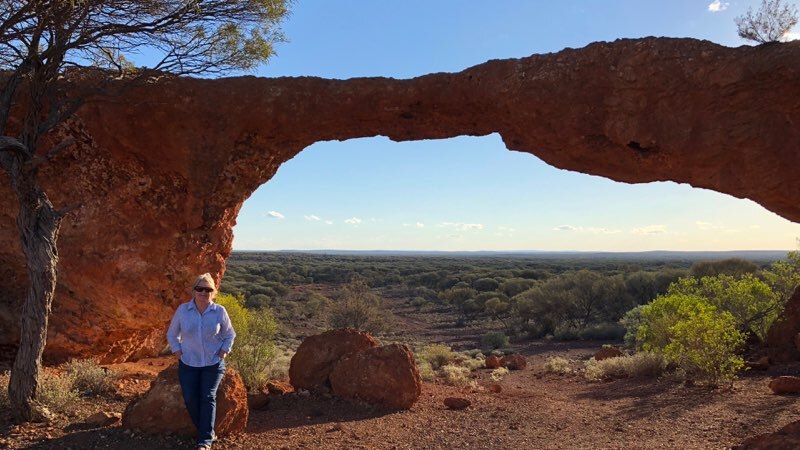 Sandstone Shire President Bethel Walton standing in front of a natural rock formation.