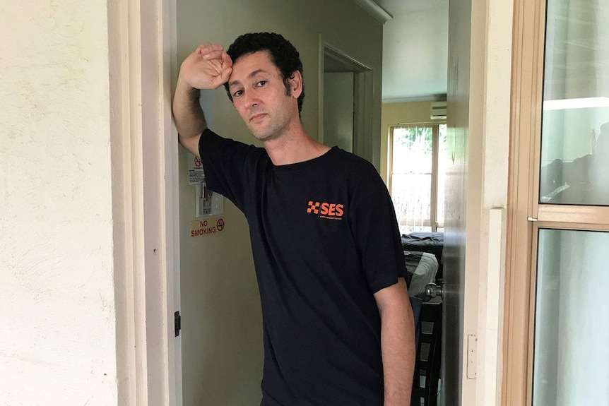 Jamie Corfield standing a doorway of a room in a house in Cairns.