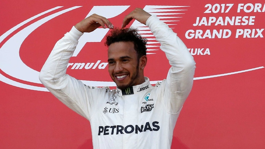 Mercedes' Lewis Hamilton of Britain gestures as he celebrates winning the Japanese Grand Prix.