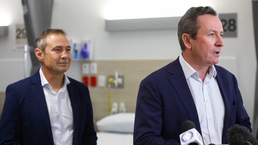 A photo of Mark McGowan and Roger Cook in a hospital room.