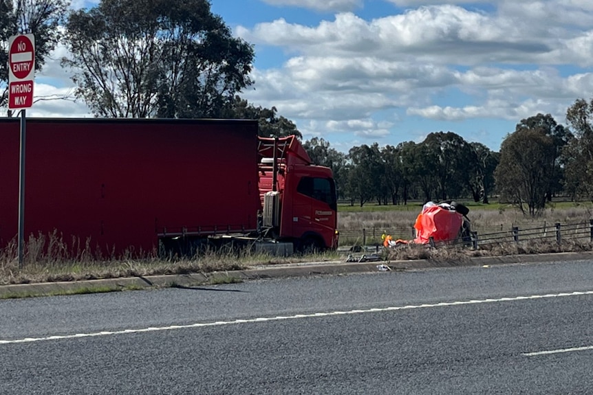 A semi-trailer on the side of a country road.