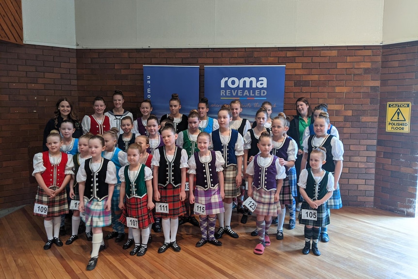 A group of highland dancers stand together.