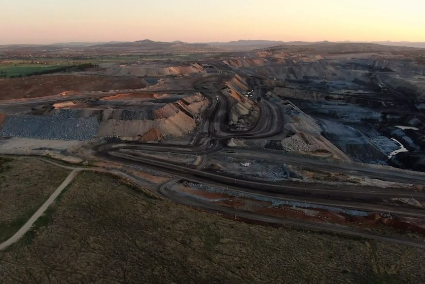 A coal mine in low light, as seen from above.