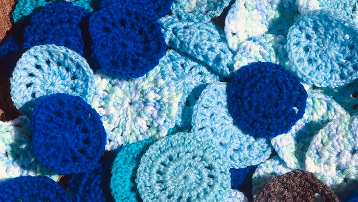 Round crocheted circles, around 9cm diameter) in hues of blue