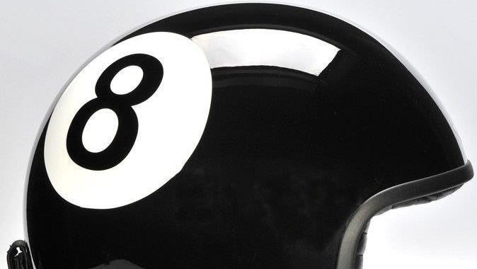 A black motorbike helmet with the number eight emblazoned on the side.