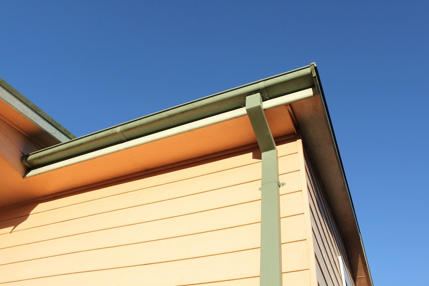 Rain gutter and drain pipe on house