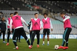 Chelsea players, wearing high-vis pink vests, during training.