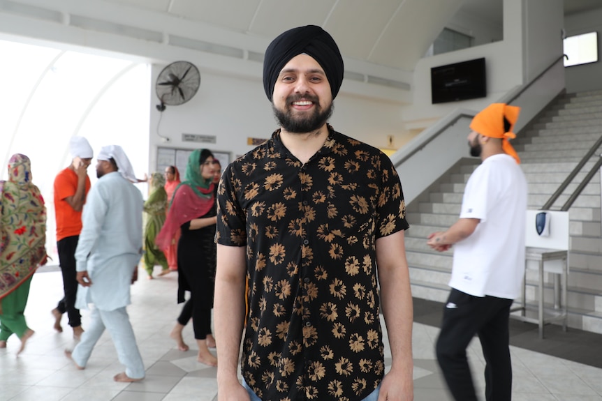 A man wearing a turban smiling