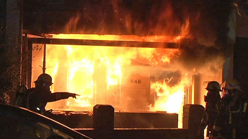 Flames burn inside a house