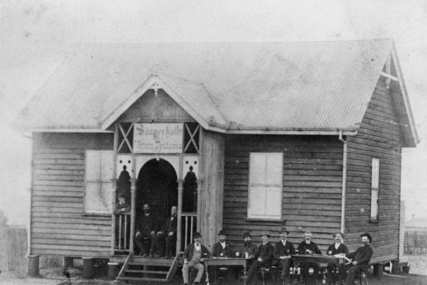 Gentleman seated around tables outside the German Club, Toowoomba 1896.