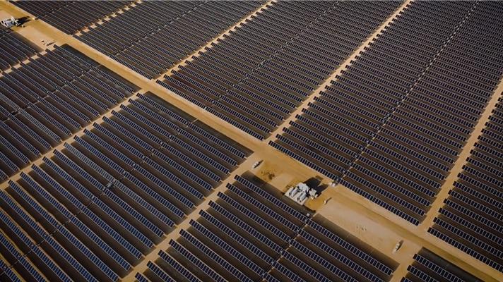 Hundreds of solar panels on a vast landscape.