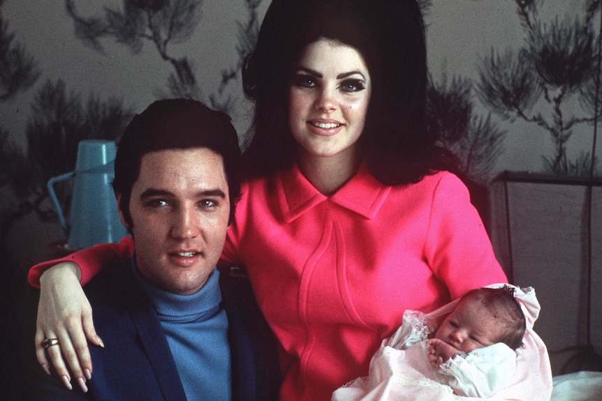 Elvis Presley poses with wife Priscilla and baby daughter Lisa Marie