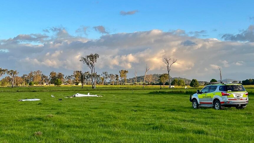 A paddock with two crashed planes in it.