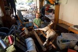 Two-year-old James surveys the flood damage at his house in The Gap.