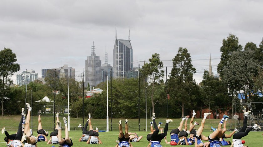 Players carry out drills during a Kangaroos training session held at Arden Street