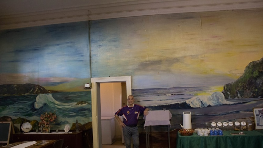 Ken Smith in front of a mural at the Grand Hotel, Boulder