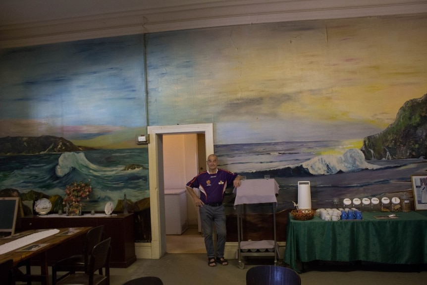 Ken Smith in front of a mural at the Grand Hotel, Boulder