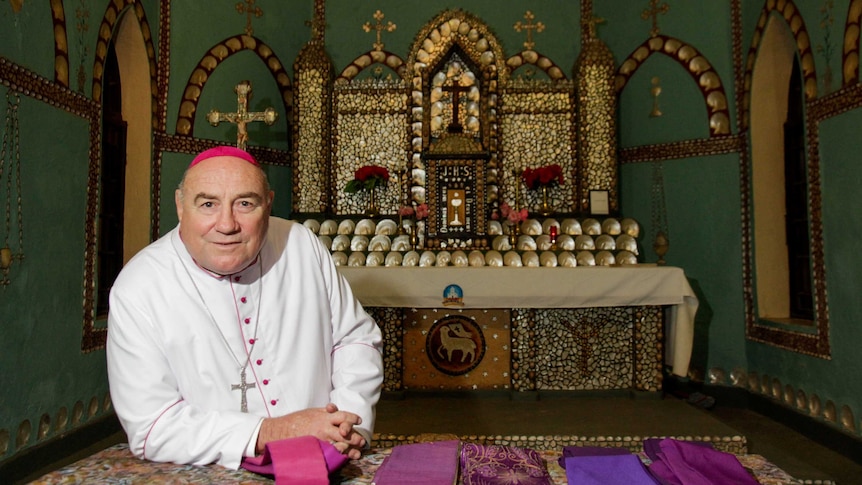 Bishop of Broome Christopher Saunders in front of pearl shell alter in the Beagle Bay church.