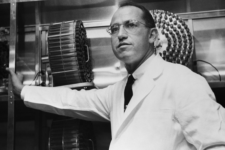 Dr Jonas Salk stands in the University of Pittsburgh laboratory in which he developed a vaccine for polio.