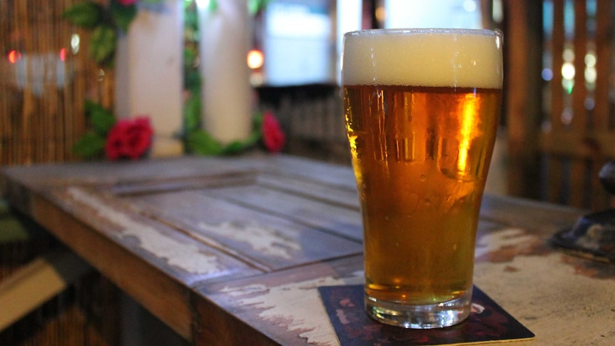 Pint of beer on a table.