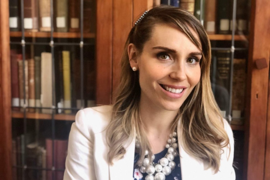 A woman smiles at the camera.