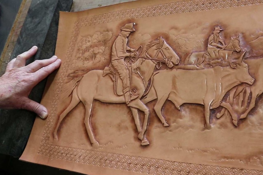 Tan coloured picture of horses and cattle with someone's hands rubbing sections.