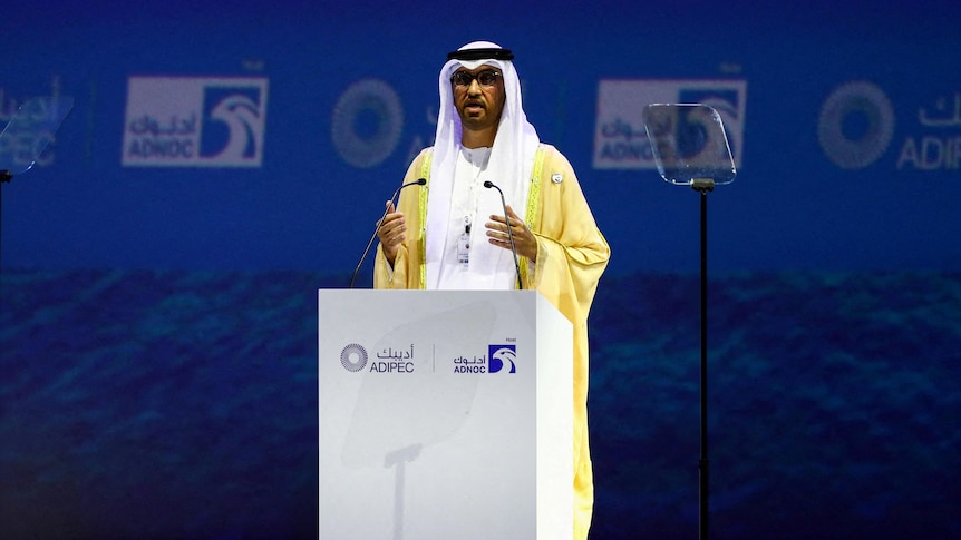 Picture of an Arab men delivering a speech at a podium 