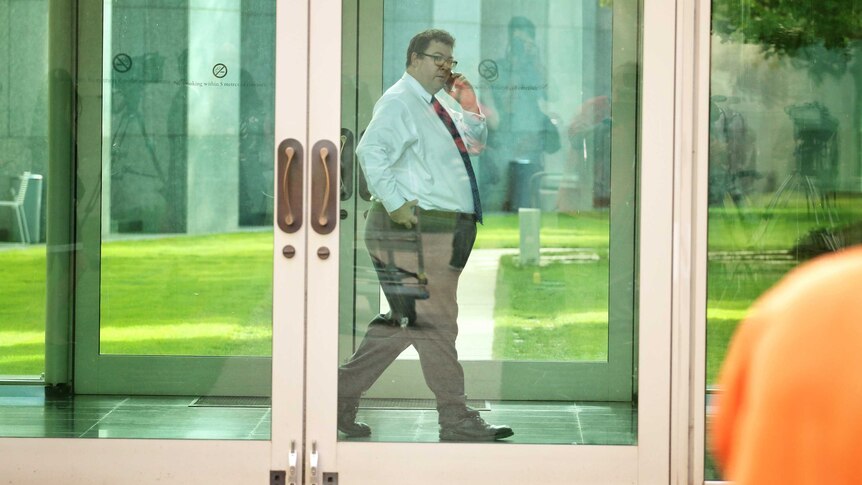MP George Christensen walks through Parliament House.